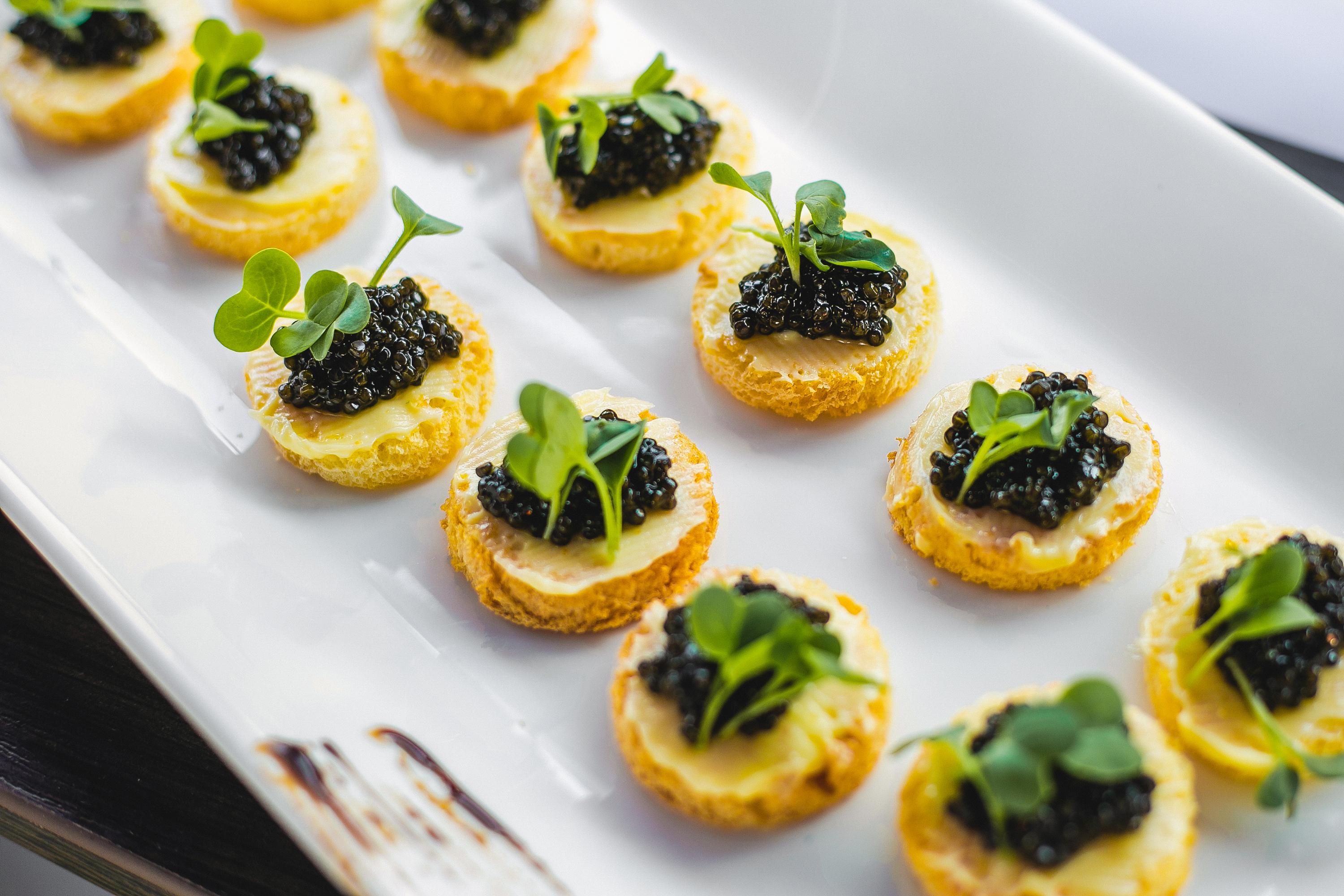 Caviar appetizers on a white platter
